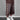 Brown wide-leg cropped pants with pearl diamond motifs and beaded drawstrings, worn with a white tee and sneakers.