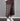 Brown wide-leg cropped pants with pearl diamond motifs and beaded drawstrings, worn with a white tee and sneakers.