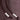 Close-up of brown knit fabric with two brown drawstrings, each tipped with three white pearl-like beads and a knot.