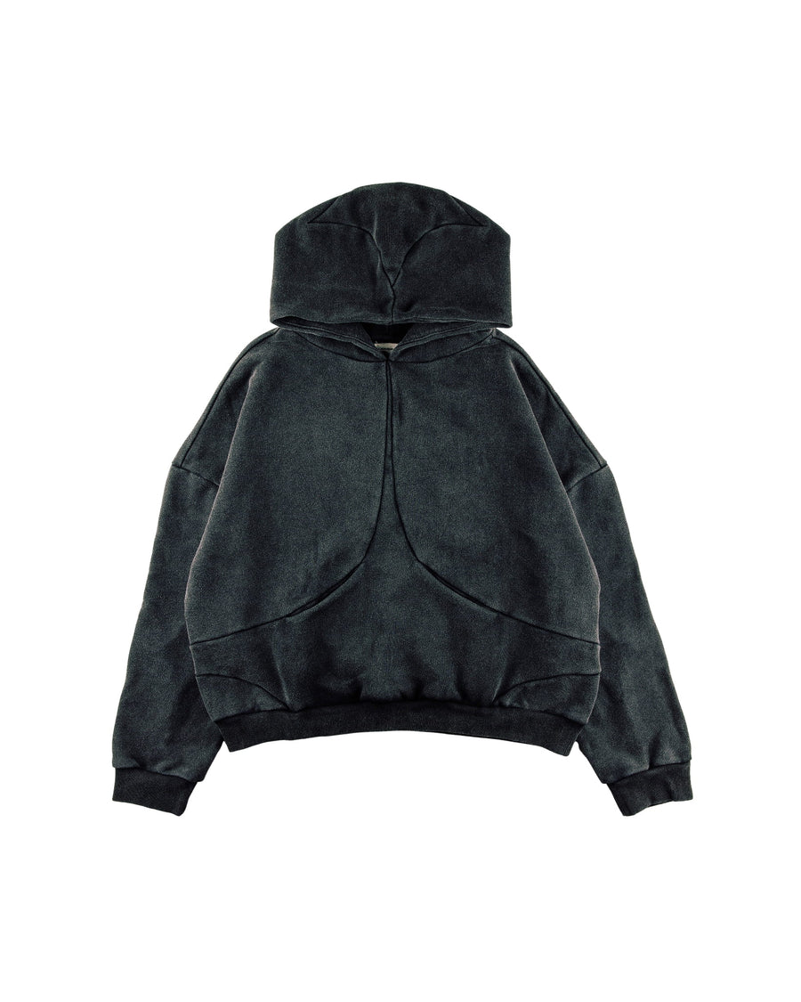 Washed charcoal pullover hoodie with curved panel seams, dropped shoulders, and ribbed cuffs and hem on a white background.