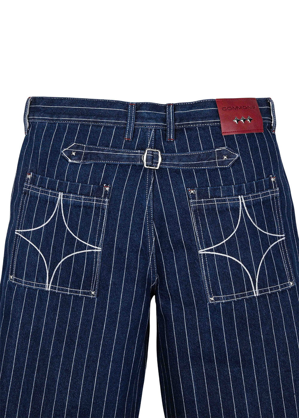 Back of dark blue pinstriped denim pants with white stitched pockets, an adjustable buckle strap, and a red logo patch.