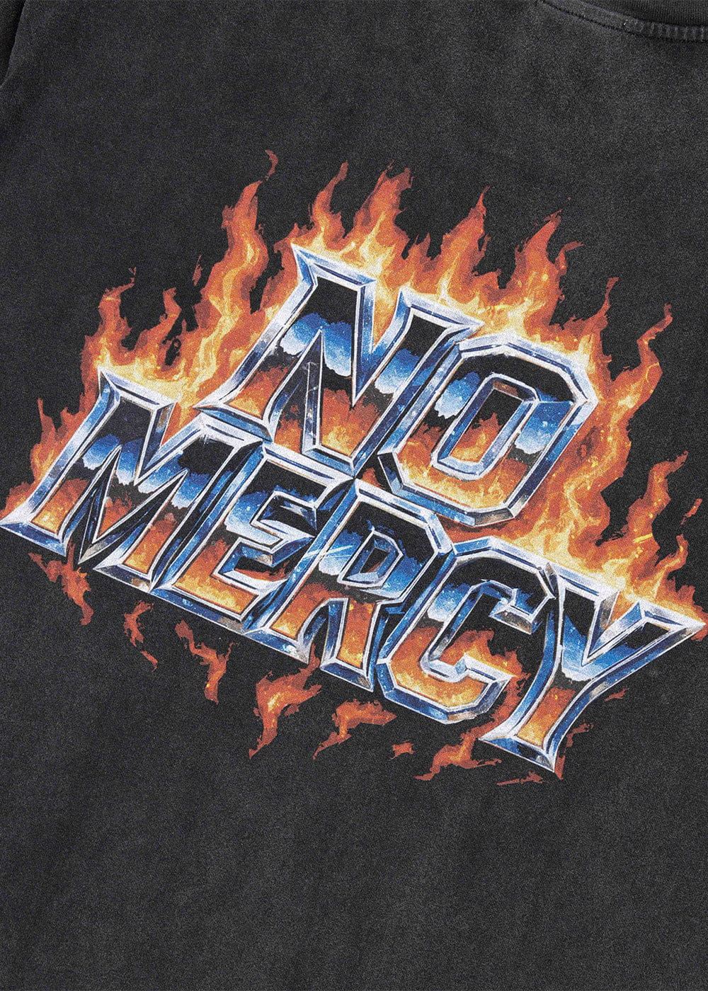 Close-up of a black T-shirt with metallic-style blue and silver NO MERCY lettering surrounded by orange and yellow flames.