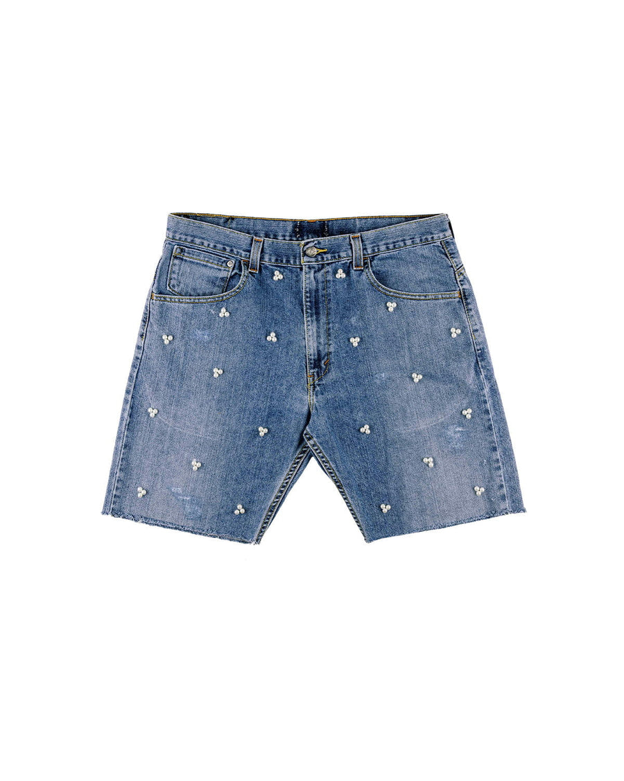 Blue denim shorts with white pearl-like bead clusters, front pockets, belt loops and raw hems on a white background.
