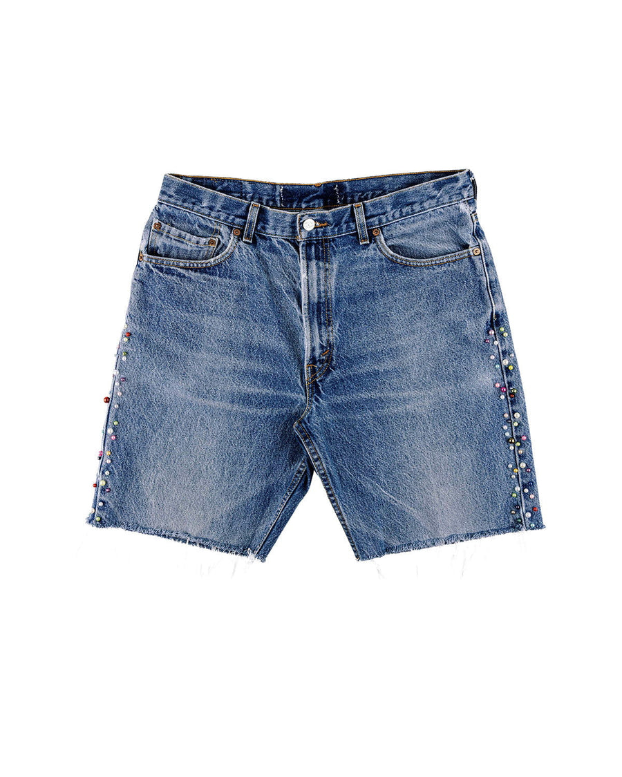Blue denim shorts with frayed hems, front pockets, and multicolored beads along the side seams on a white background.